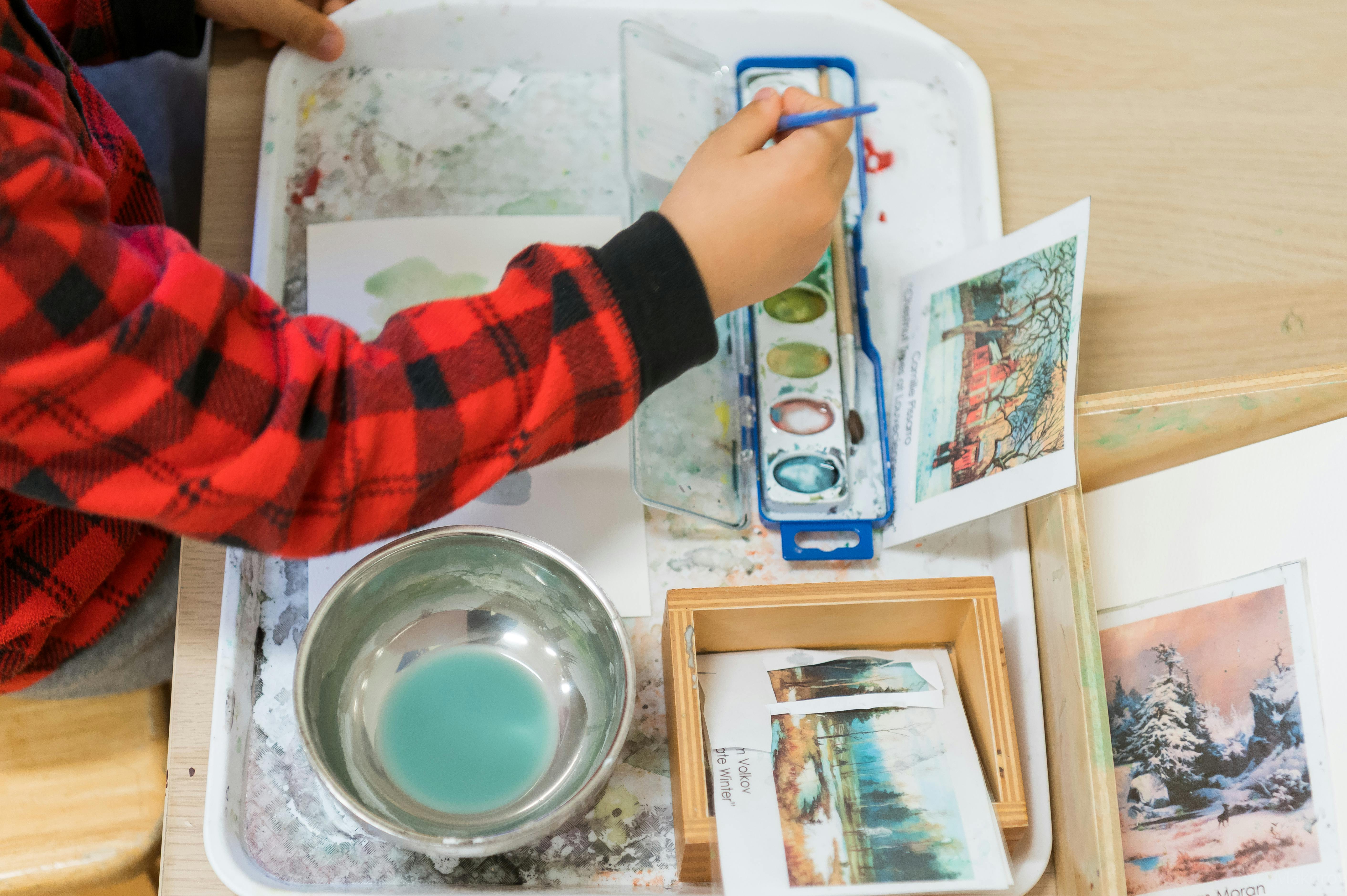 Child painting with watercolors