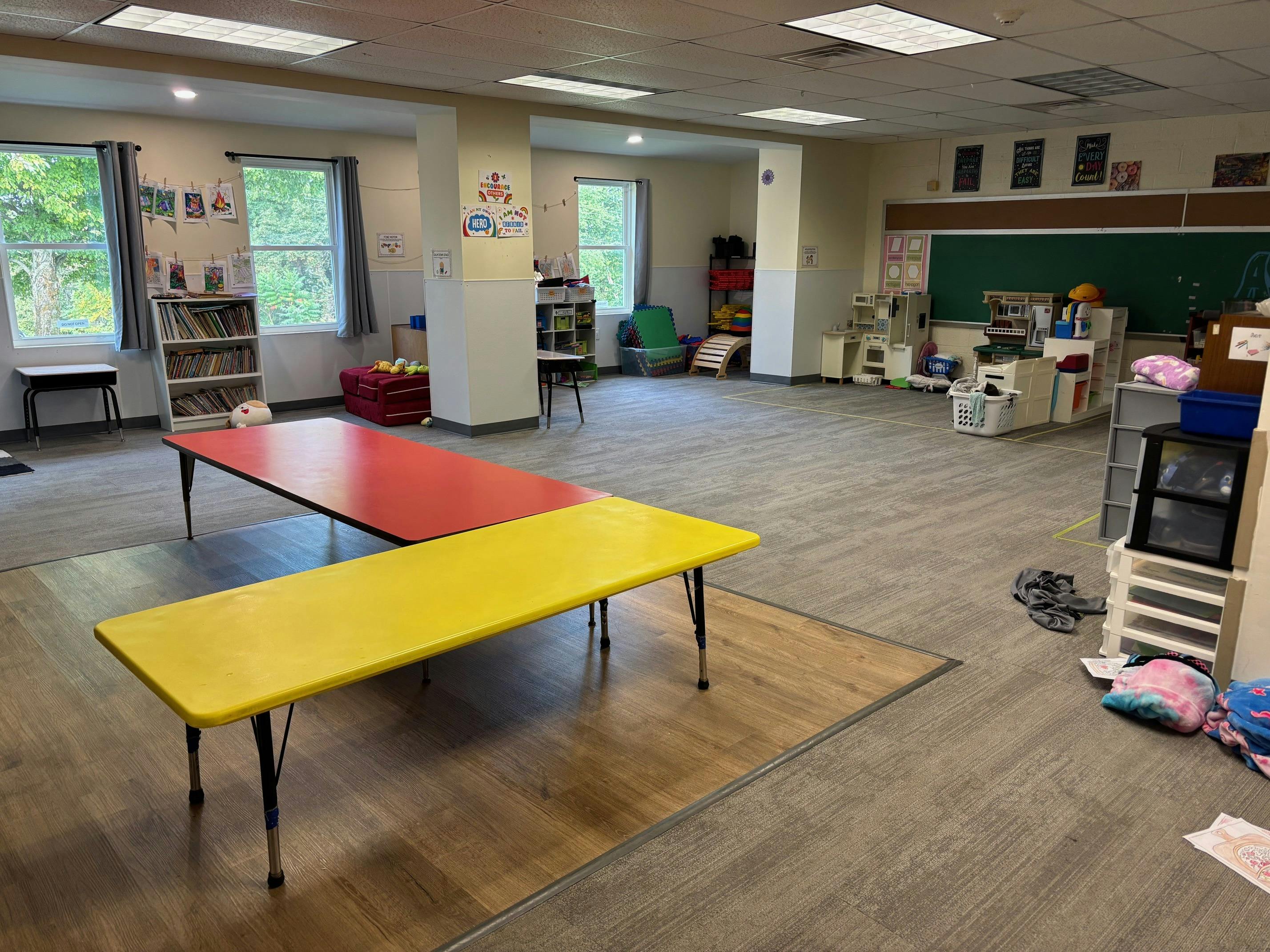 Empty classroom with red and yellow tables