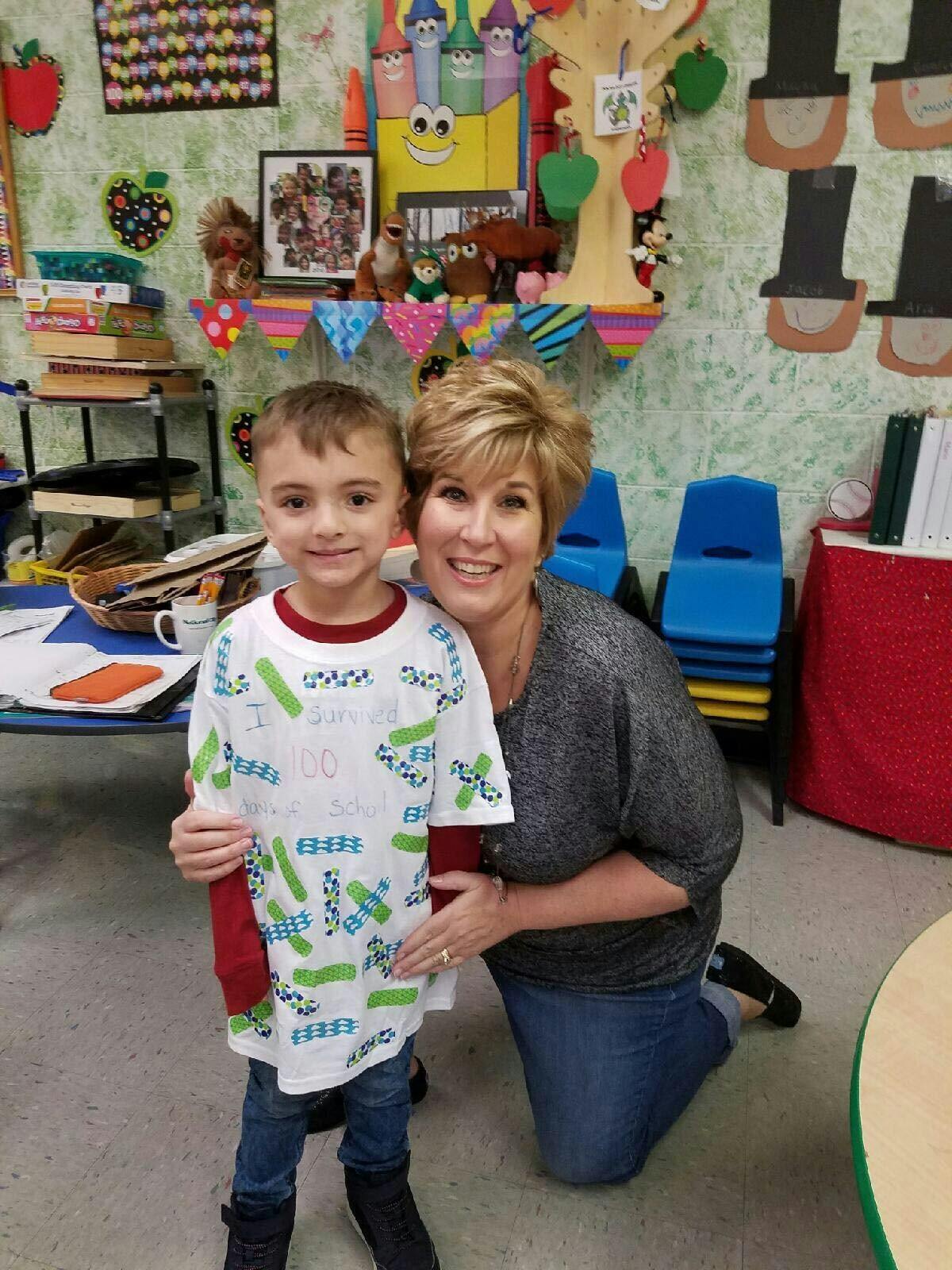 Adult and child posing in a classroom