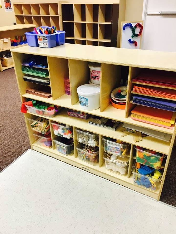 Classroom storage unit with art supplies and paper
