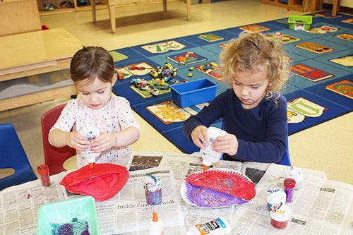 Two children doing crafts at a table
