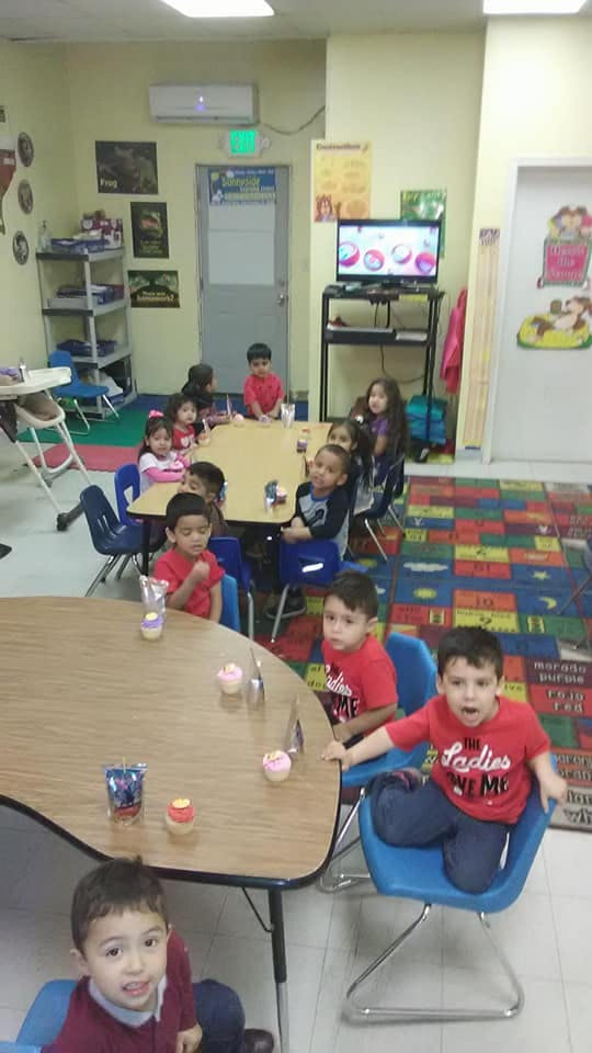 Children sitting at tables in a classroom
