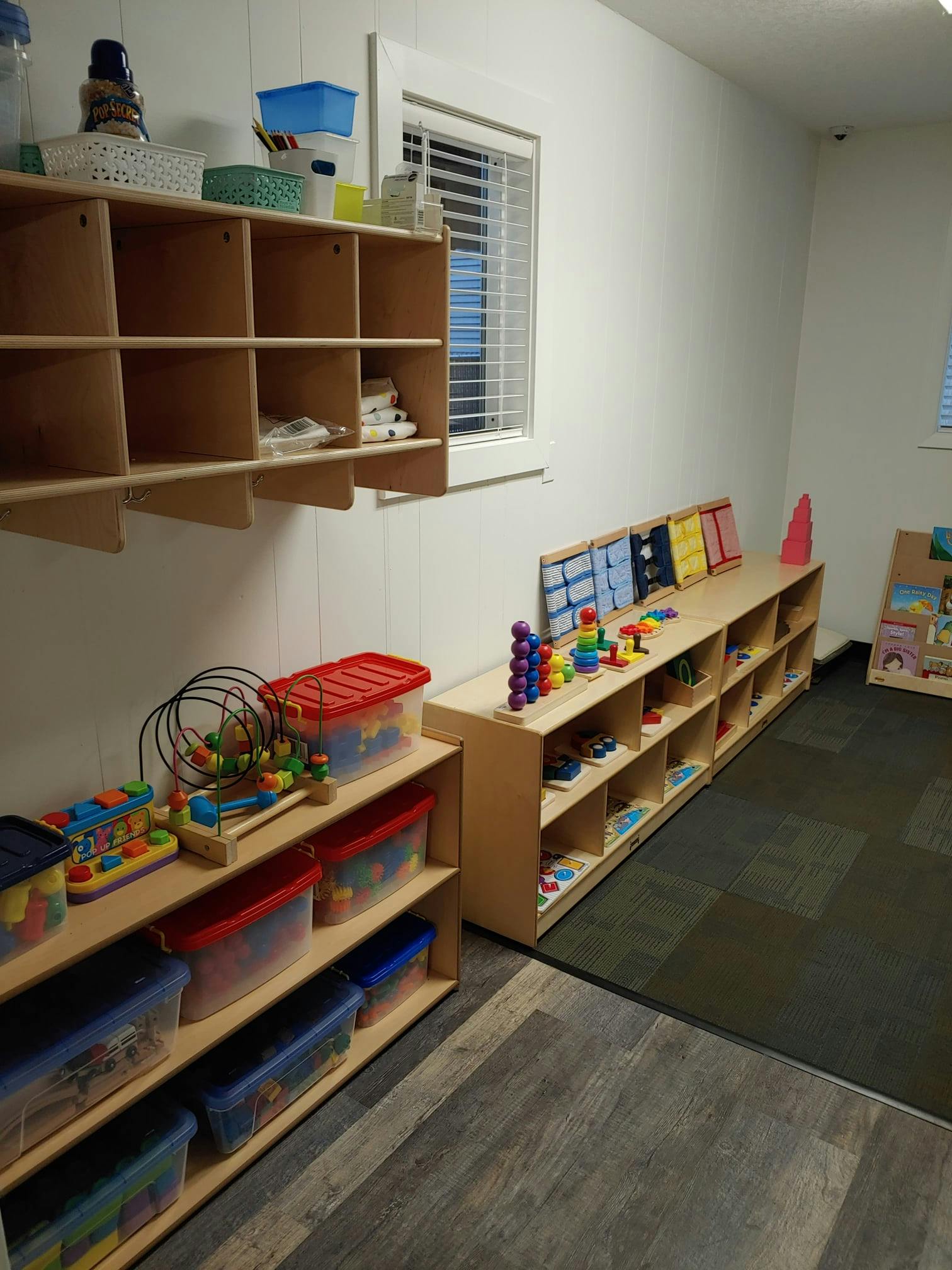 Classroom with shelves of toys and storage bins