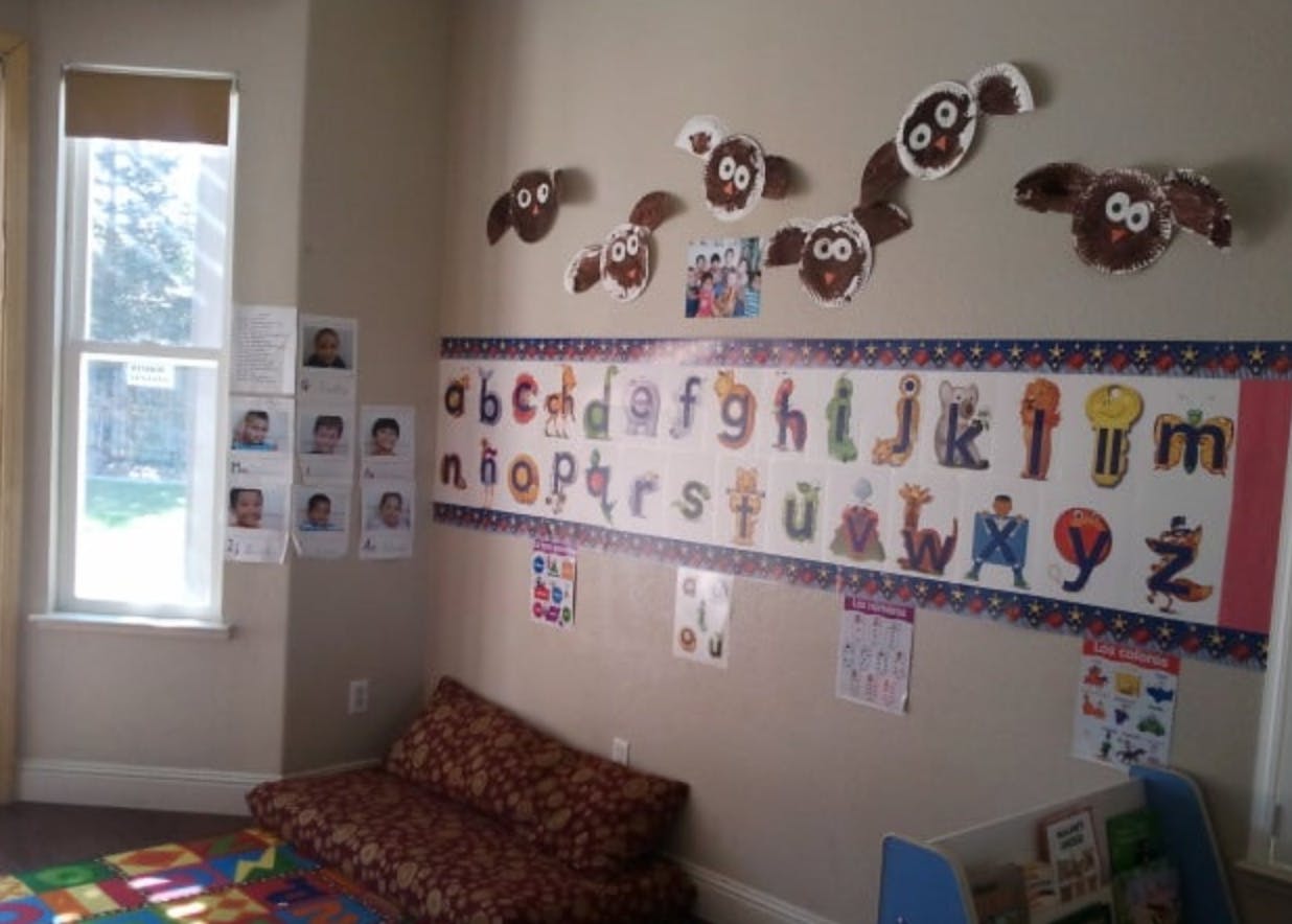 Classroom wall with alphabet chart and sheep decorations