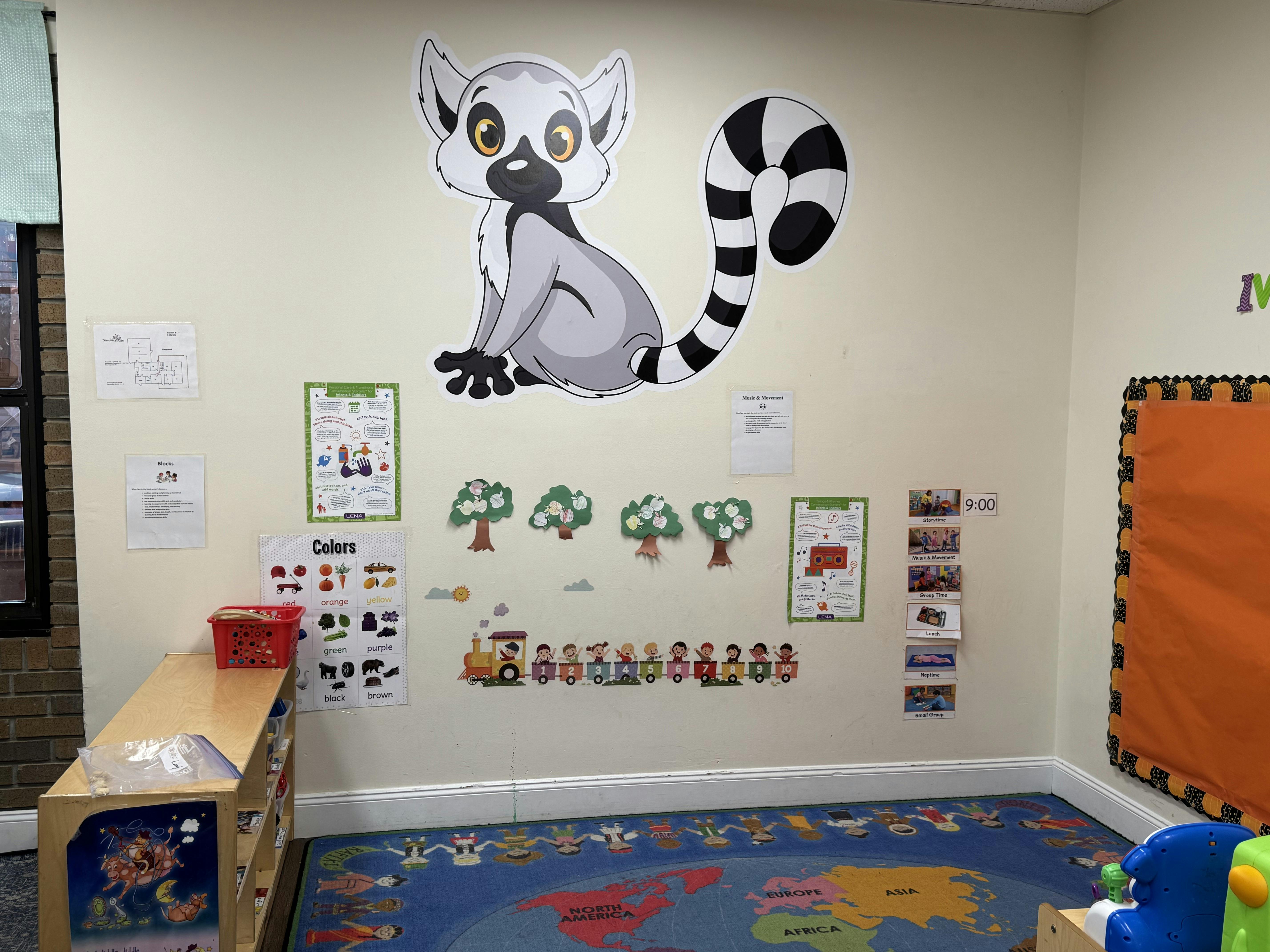 Classroom wall with a large lemur cutout and educational decorations