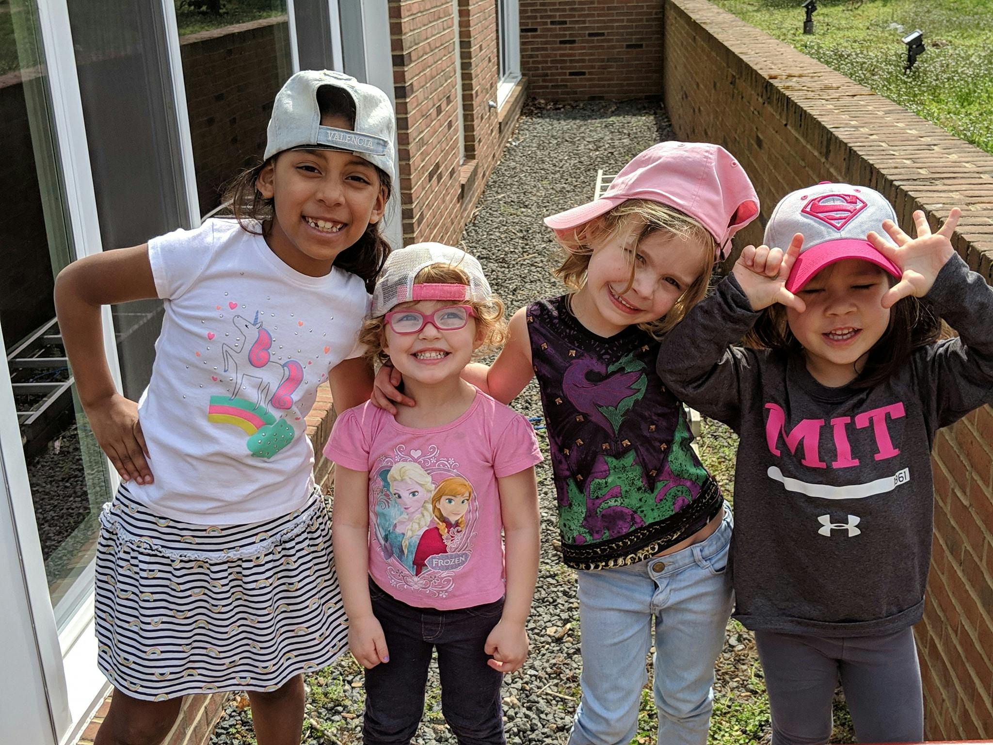 Four children posing for a photo outdoors