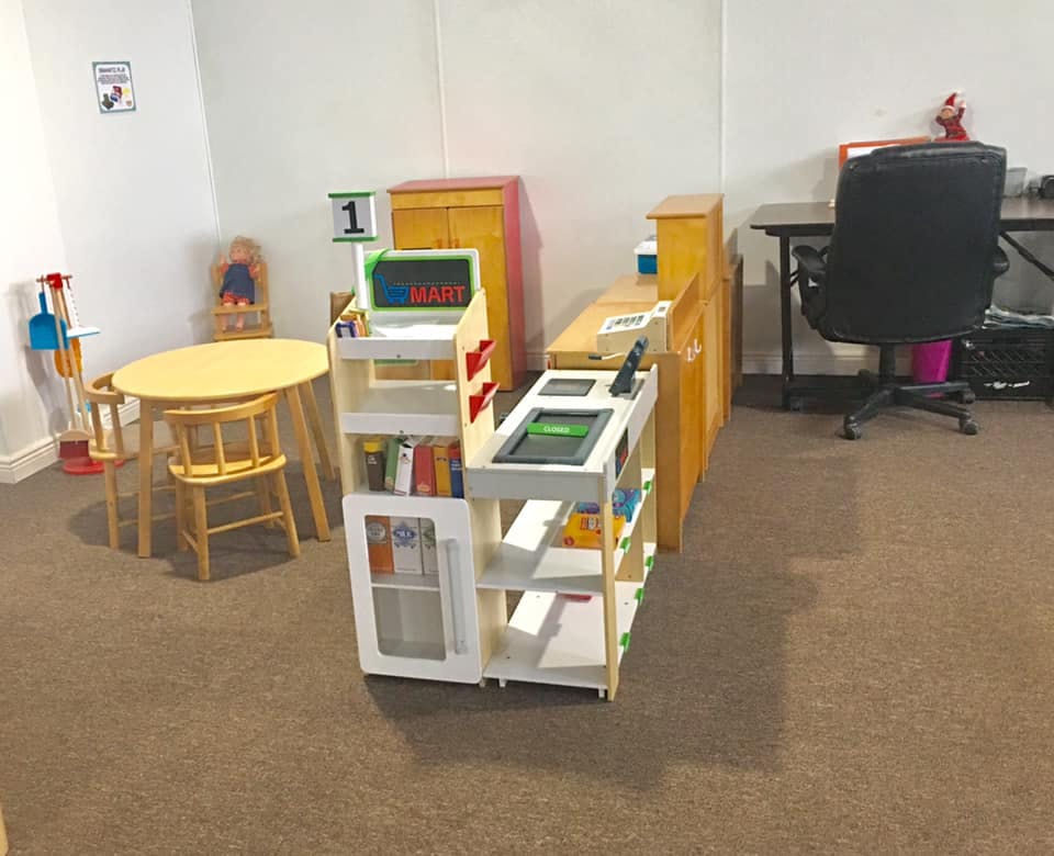 Play kitchen and table with chairs in a room