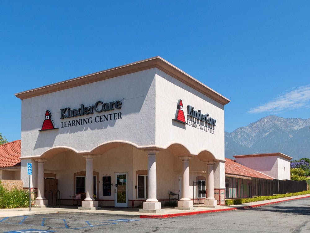 KinderCare Learning Center building with mountains in the background