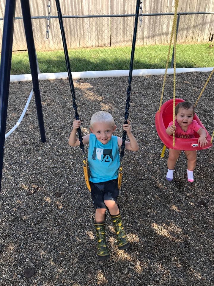 Two children on swings at a playground