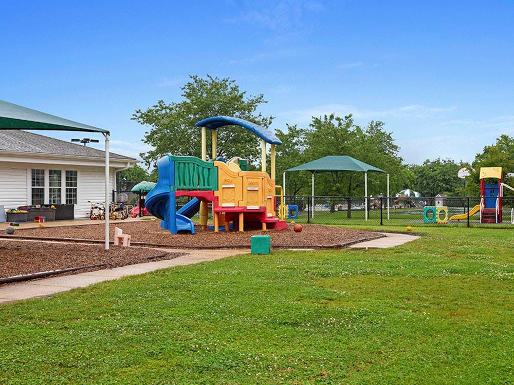 Colorful playground with slides, swings, and other play equipment
