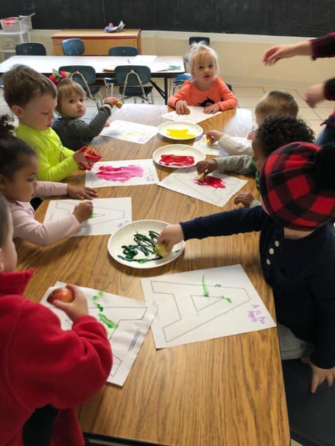 Children painting at a table