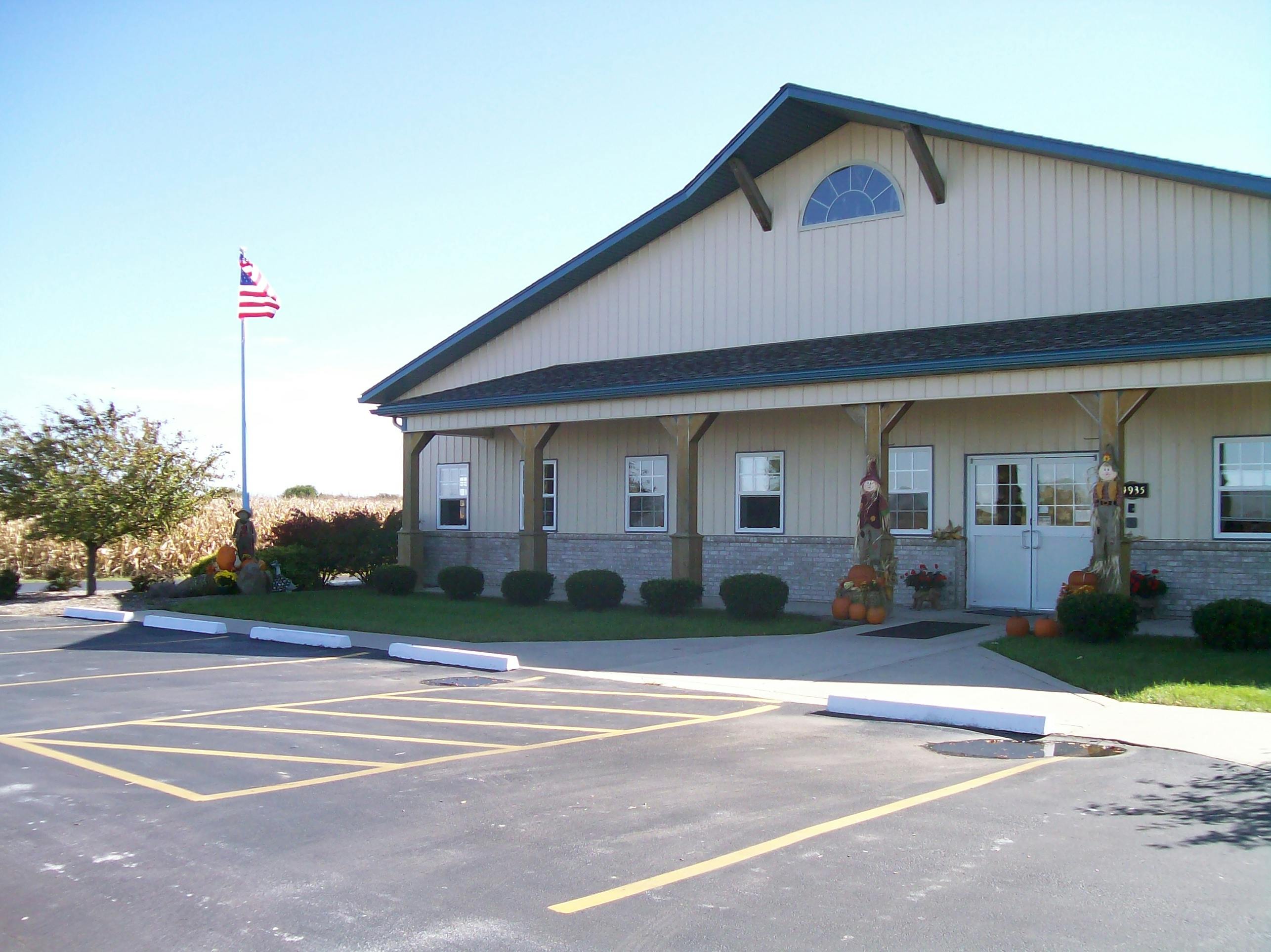 Building with a parking lot and an American flag