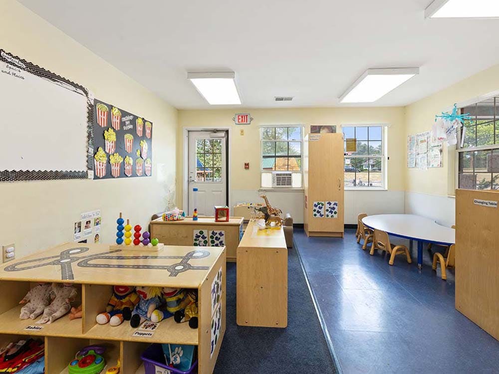 Classroom with child-sized furniture, toys, and a popcorn-themed bulletin board