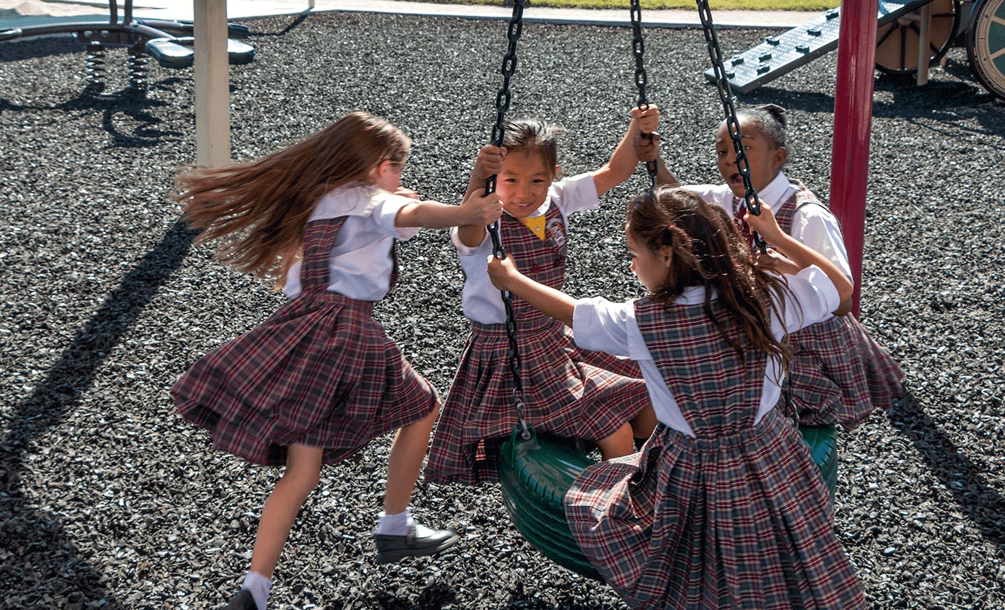 Children playing on a tire swing on a playground