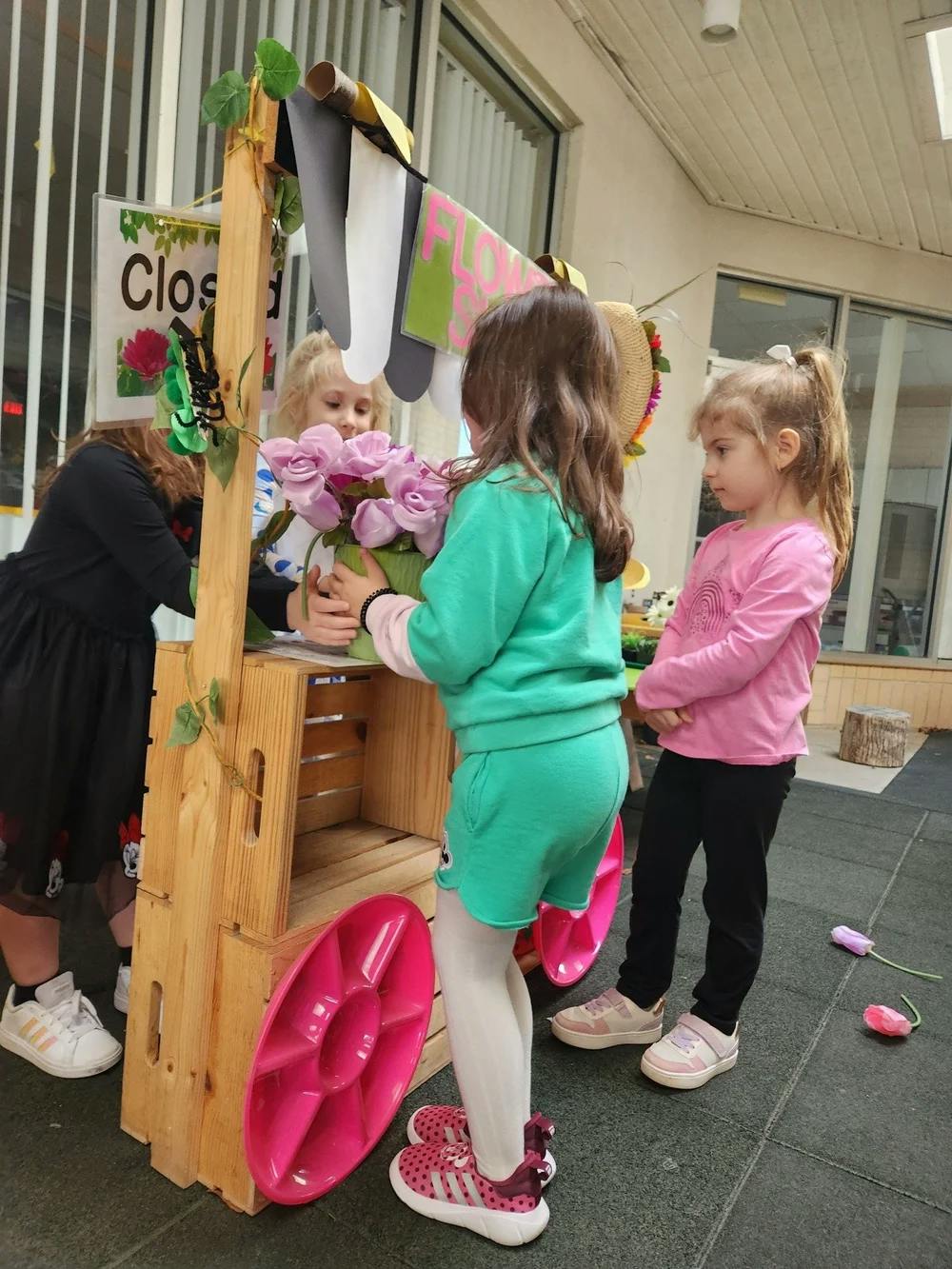 Children playing with a flower stand