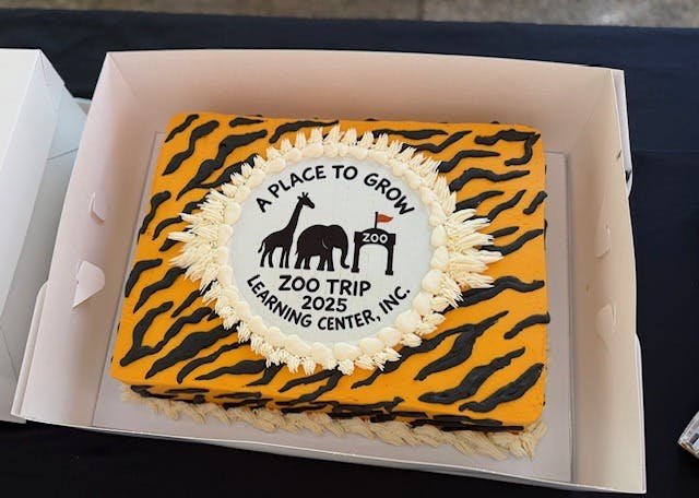 Tiger print cake with a zoo trip logo that says "A Place to Grow"