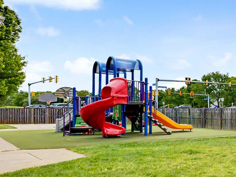 Colorful playground structure with slides on a green surface