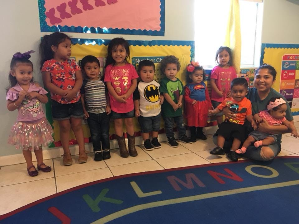 Group of children and an adult in a classroom