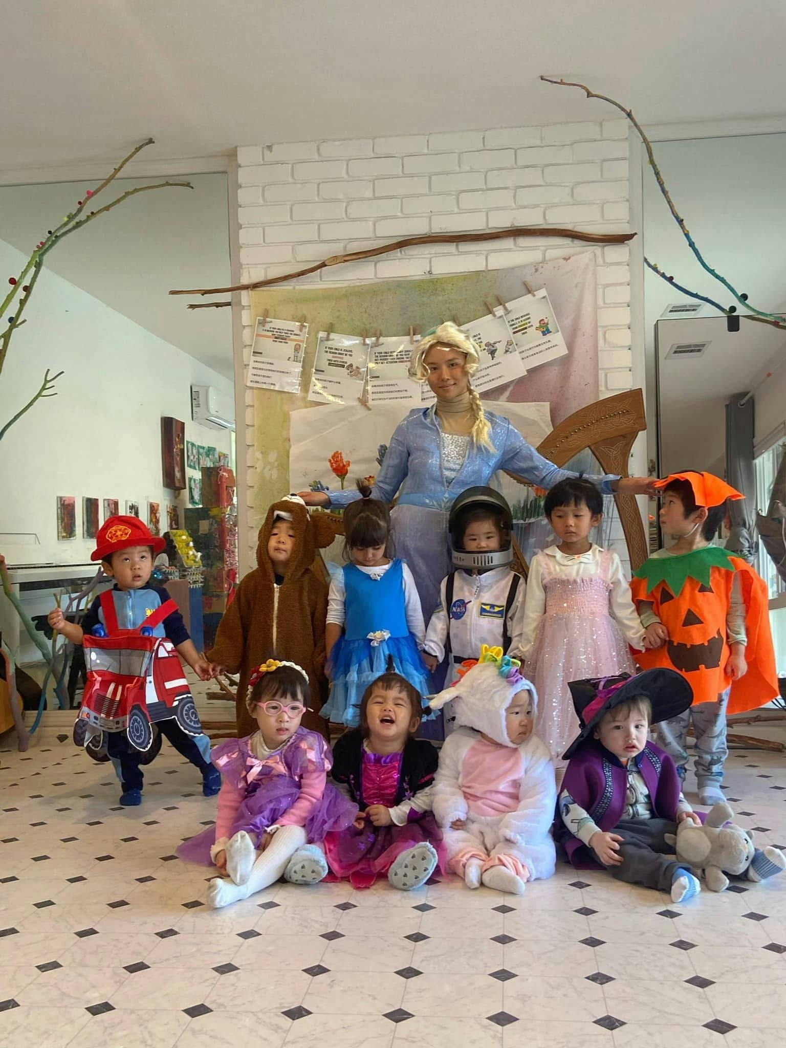 Adult and children in various costumes posing together