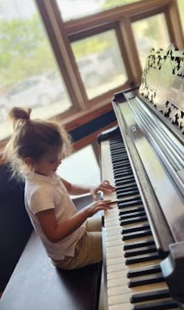 Child playing a piano