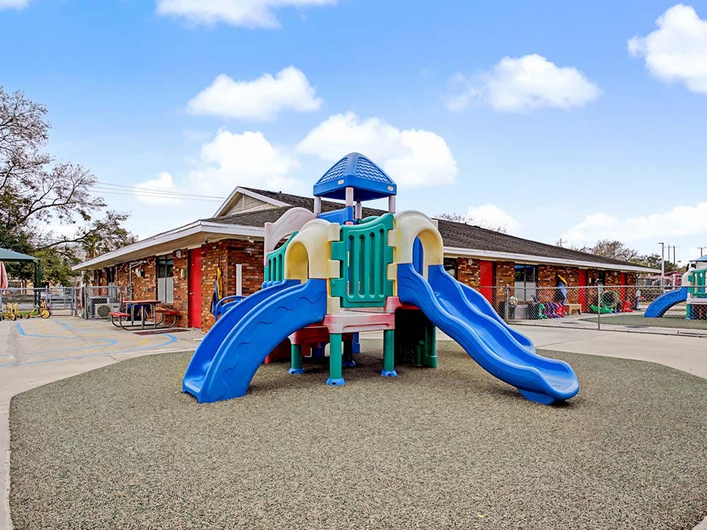 Colorful playground structure with slides on a soft-surface ground