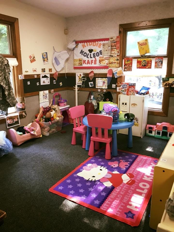 Playroom with small table and chairs, toys, and a Hello Kitty rug
