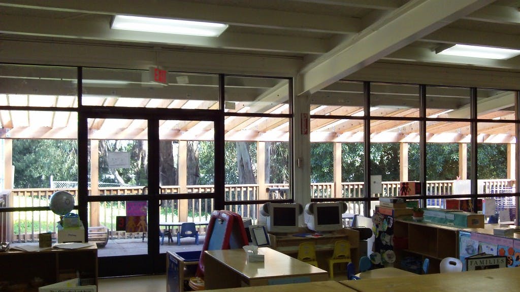 Classroom interior with large windows looking out onto a deck