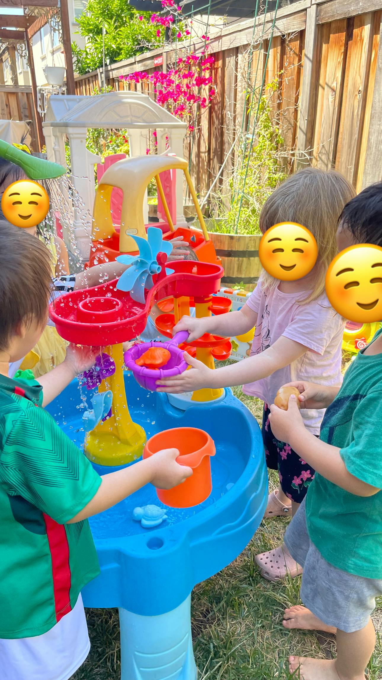 Children playing with a water table outdoors