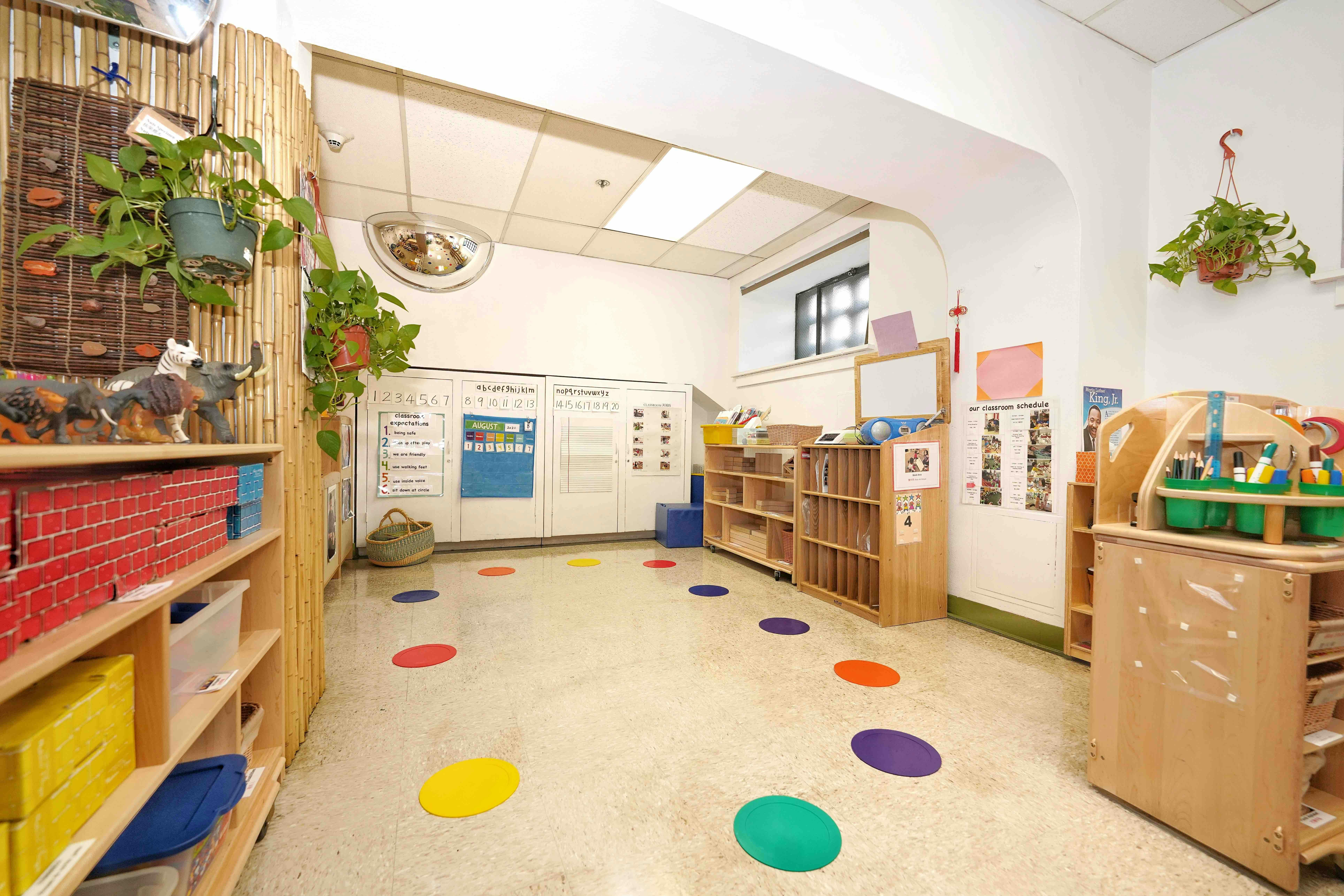 Classroom interior with educational materials and colorful floor markers