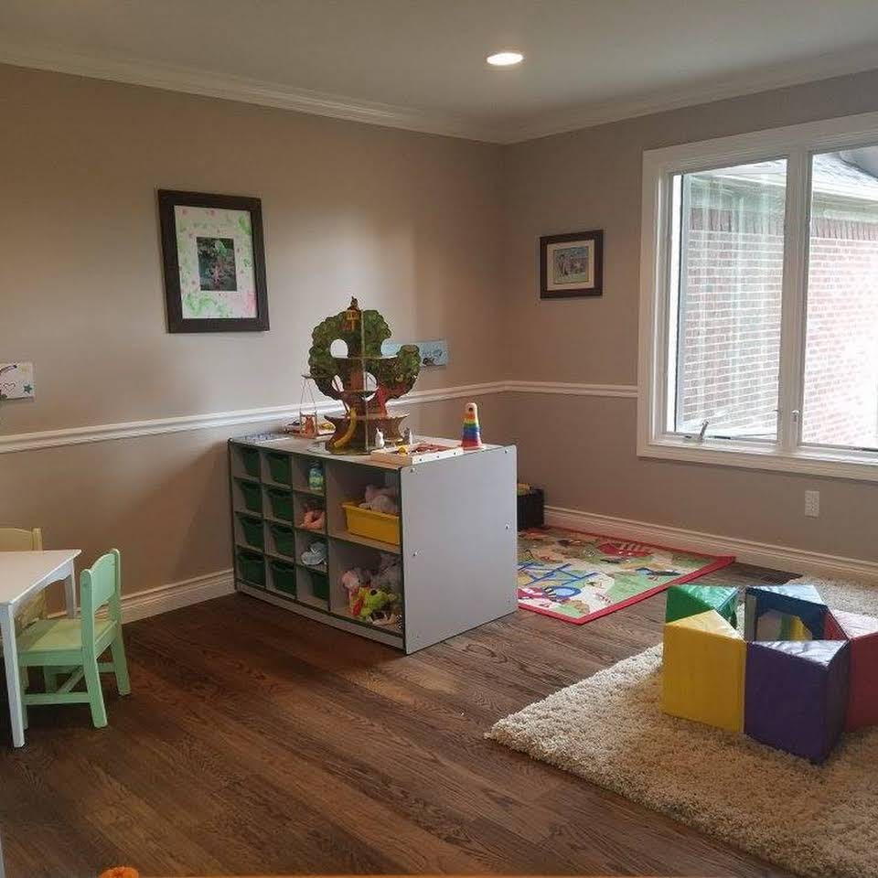 Playroom with toy storage, small table and chairs, and colorful blocks