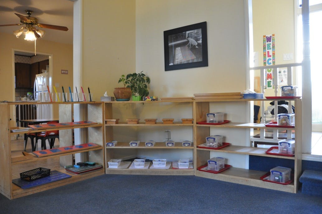 Wooden shelves with various learning materials in a classroom
