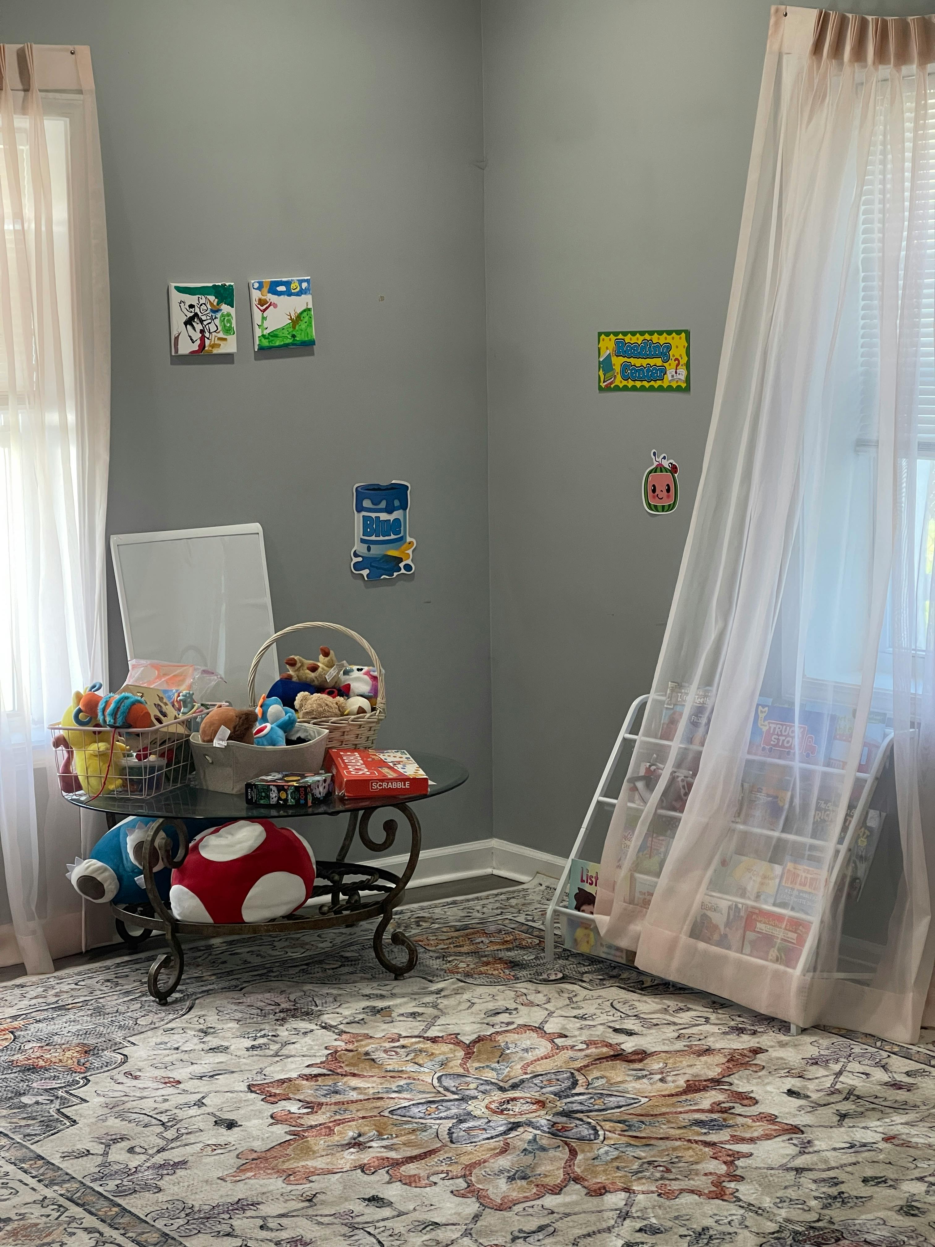 Playroom with a table of toys and a book display