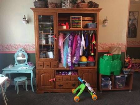 Children's dress-up clothes and toys in a room