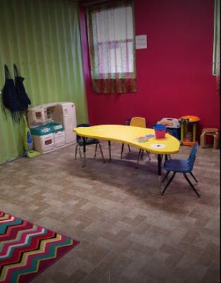 Playroom with a yellow table and chairs