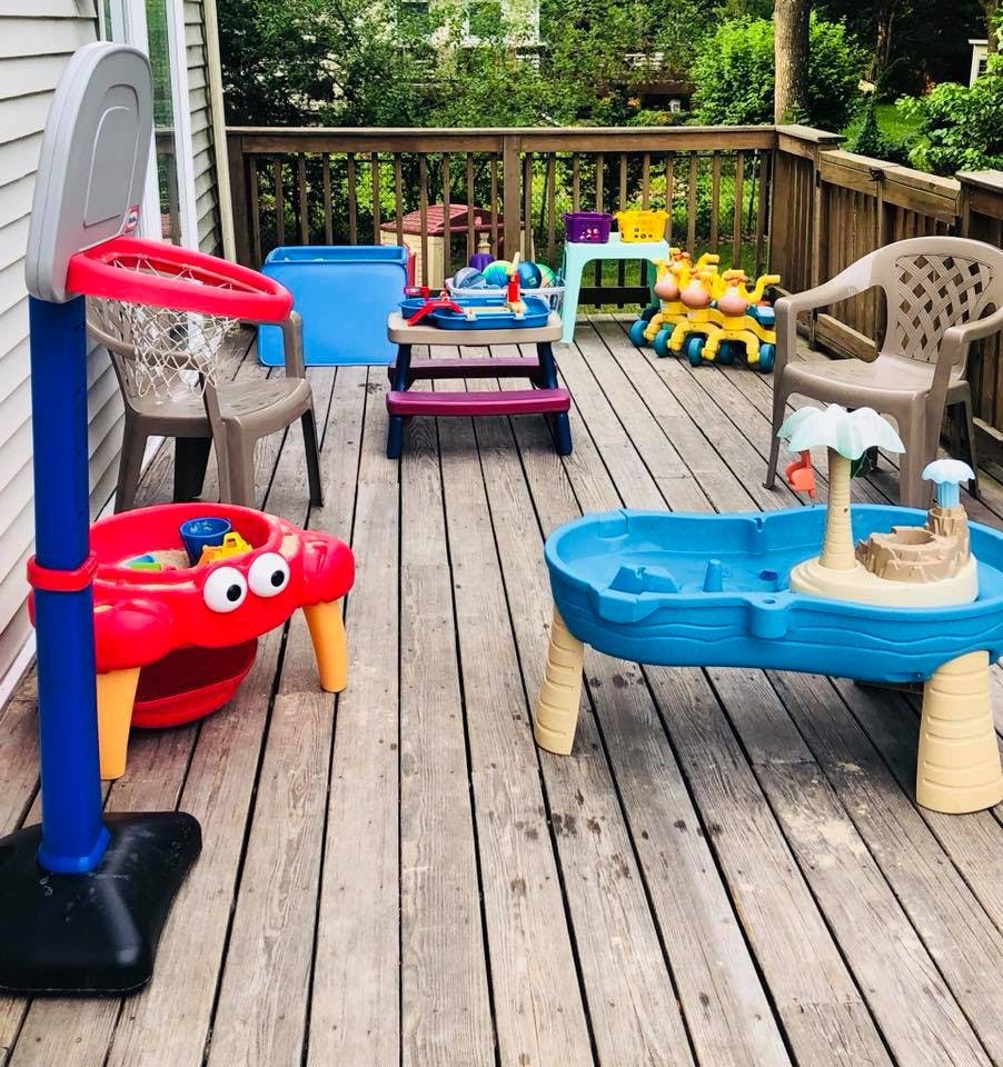 Children's play area on a wooden deck with various toys