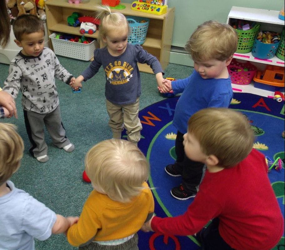 Group of children holding hands in a circle