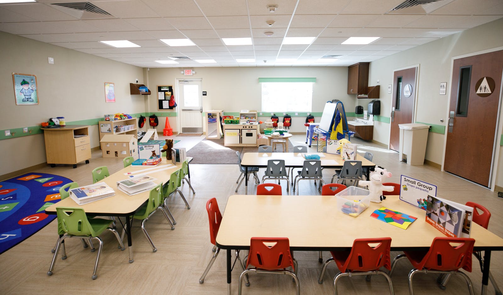 Empty classroom with small tables and chairs