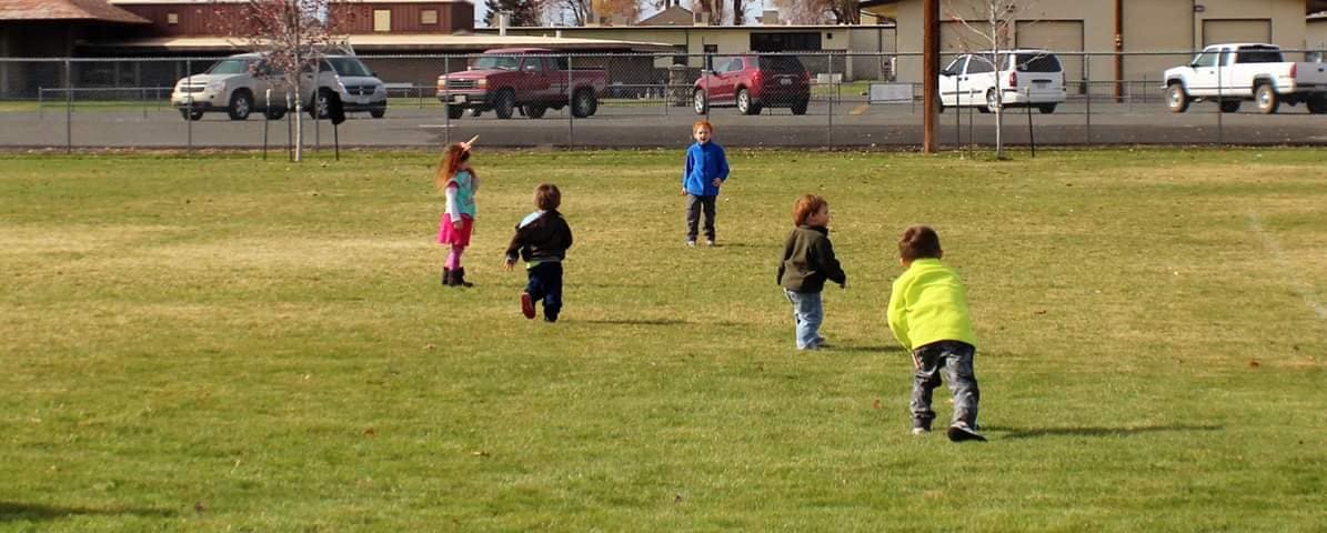 Children playing on a grassy field