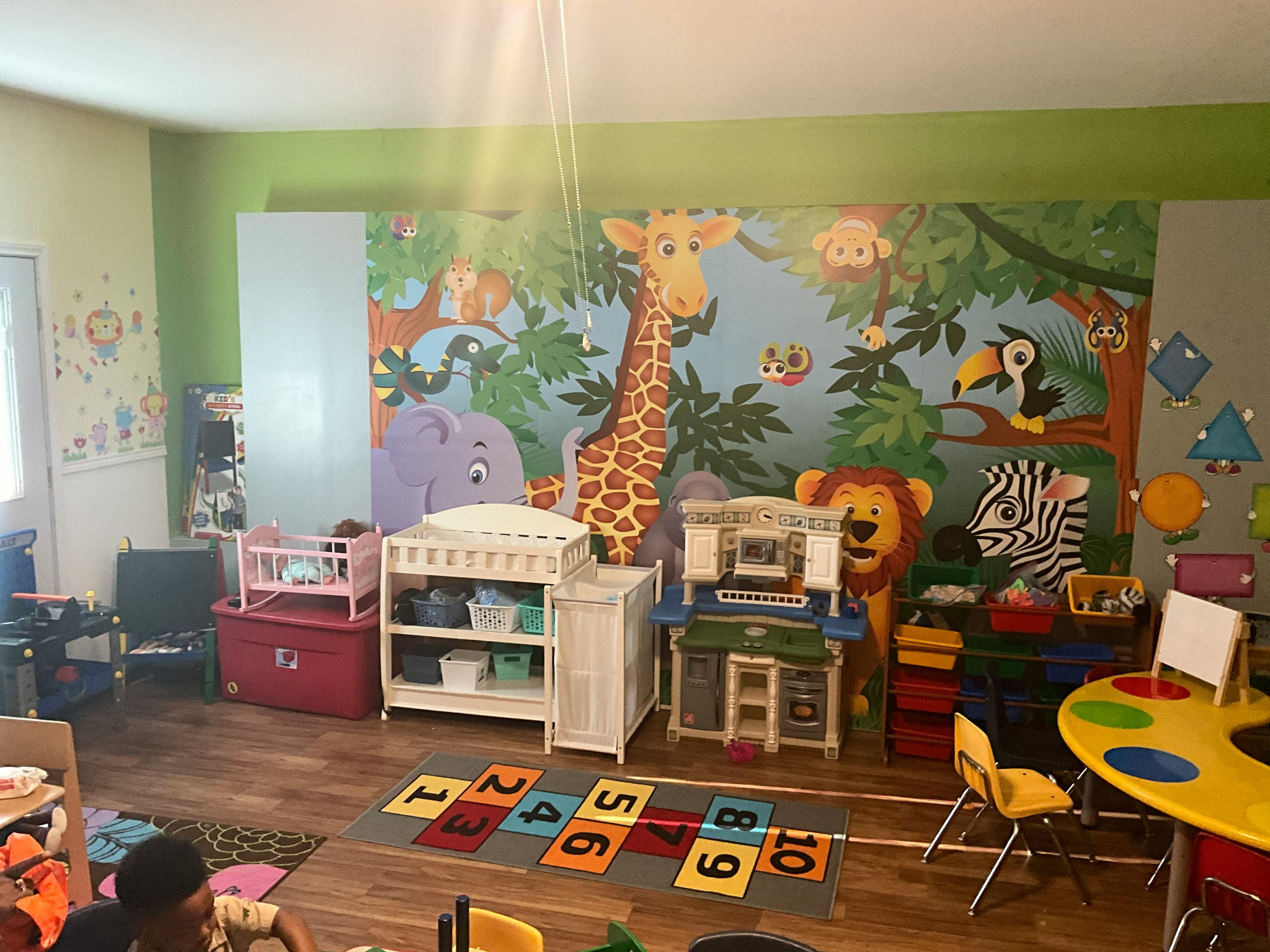 Playroom with jungle mural, changing table, and toys