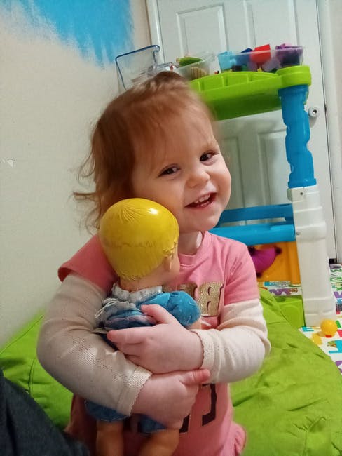 Child holding a doll