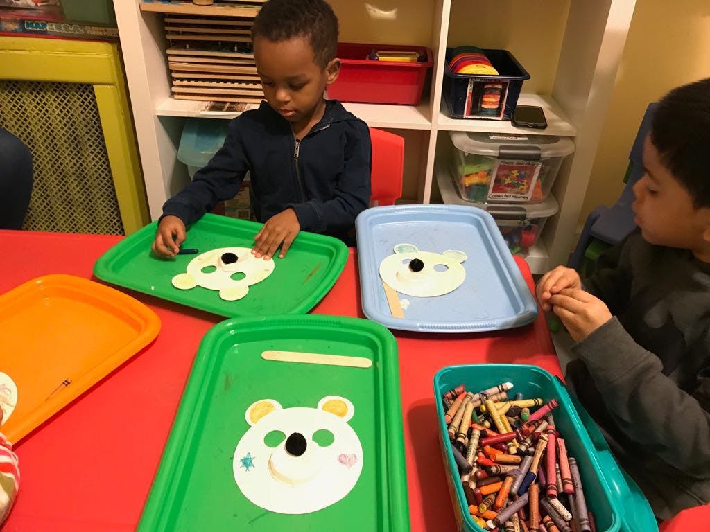 Two children doing crafts at a table