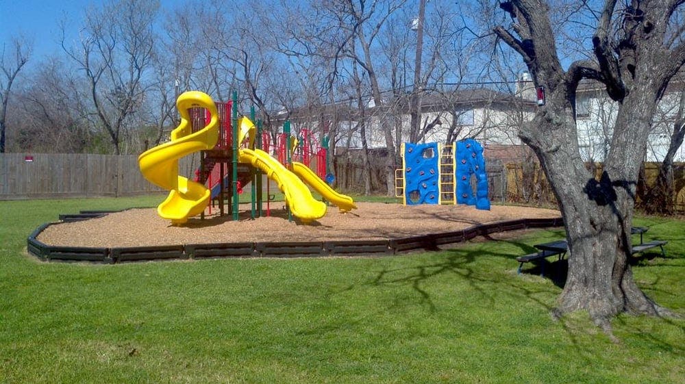 Playground with yellow slides and blue climbing walls
