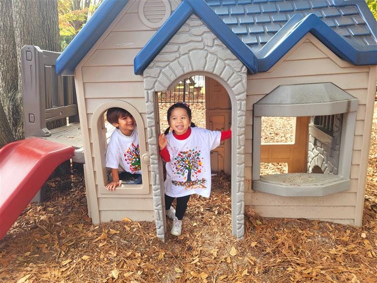 Two children playing in a playhouse