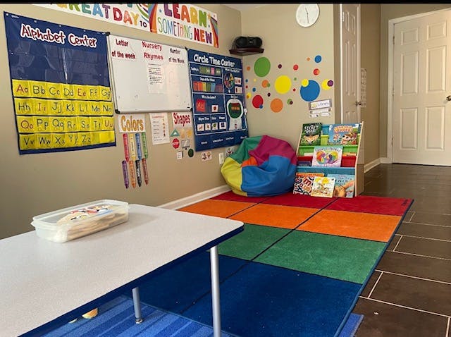 Classroom with alphabet chart, whiteboard, colorful rug, and beanbag chair