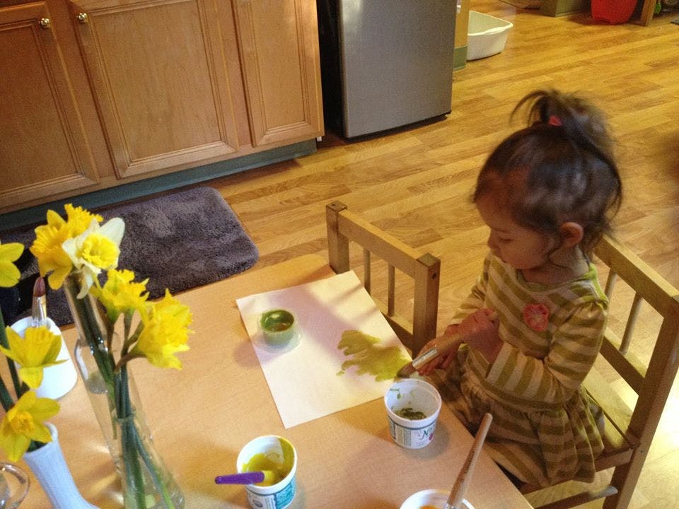 Child painting at a table