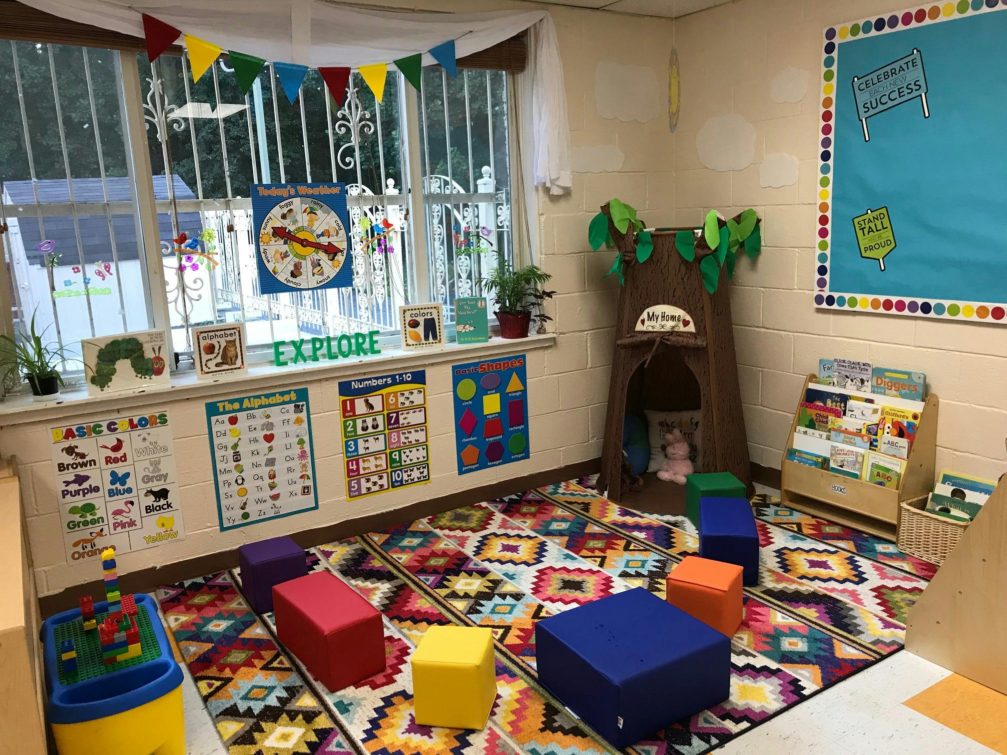 Colorful classroom with a patterned rug, window, and learning materials