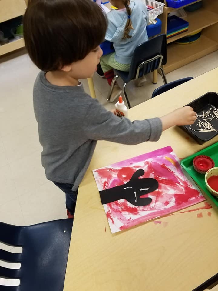 Child working on an art project at a table
