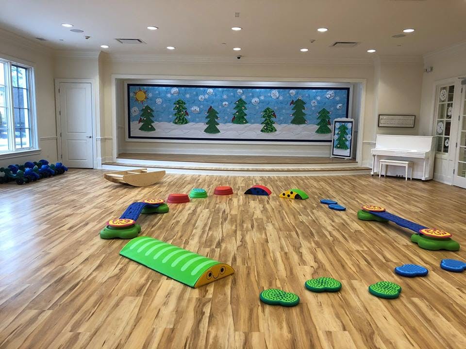 Indoor play area with colorful soft play equipment on a wooden floor
