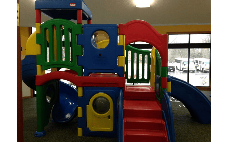 Colorful indoor playground structure with slides and steps