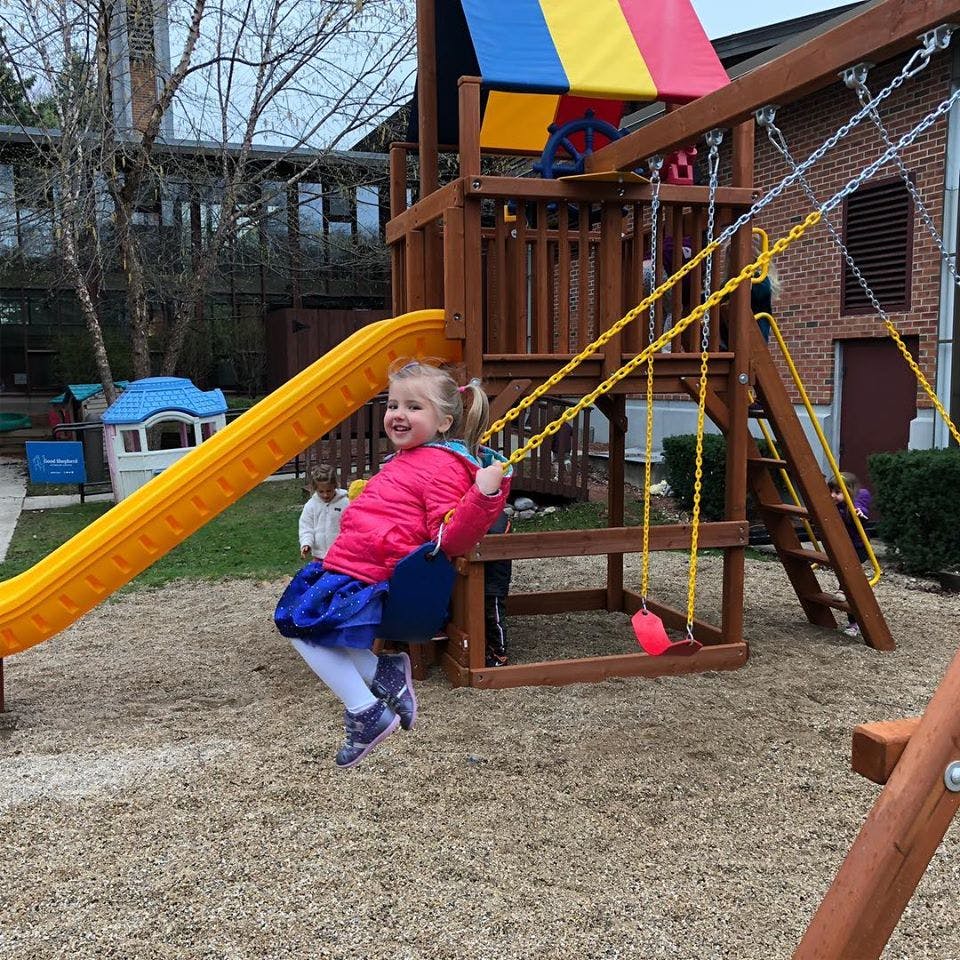 Child on a swing set at a playground